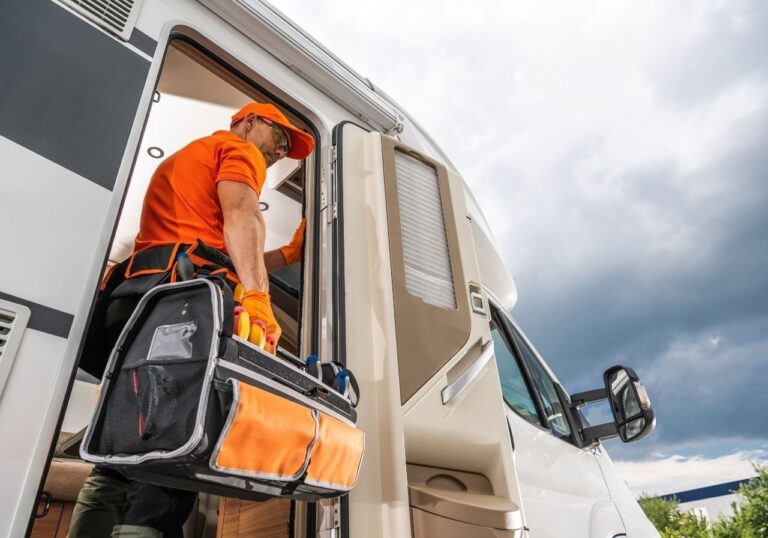 RV technician working at Lake Mead RV Village with scenic Nevada backdrop