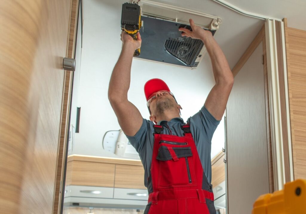 RV owner shaking hands with technician after quick AC fix in residential driveway