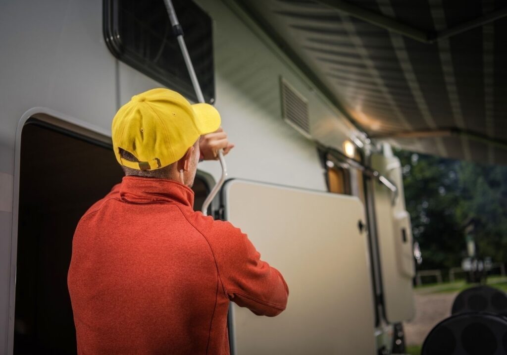 Clock overlay next to RV awning technician arriving on-site for emergency same-day repair