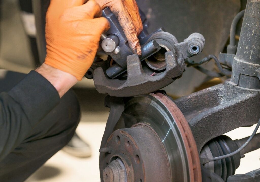 Close-up of worn RV brake pads and wheel hub before repair