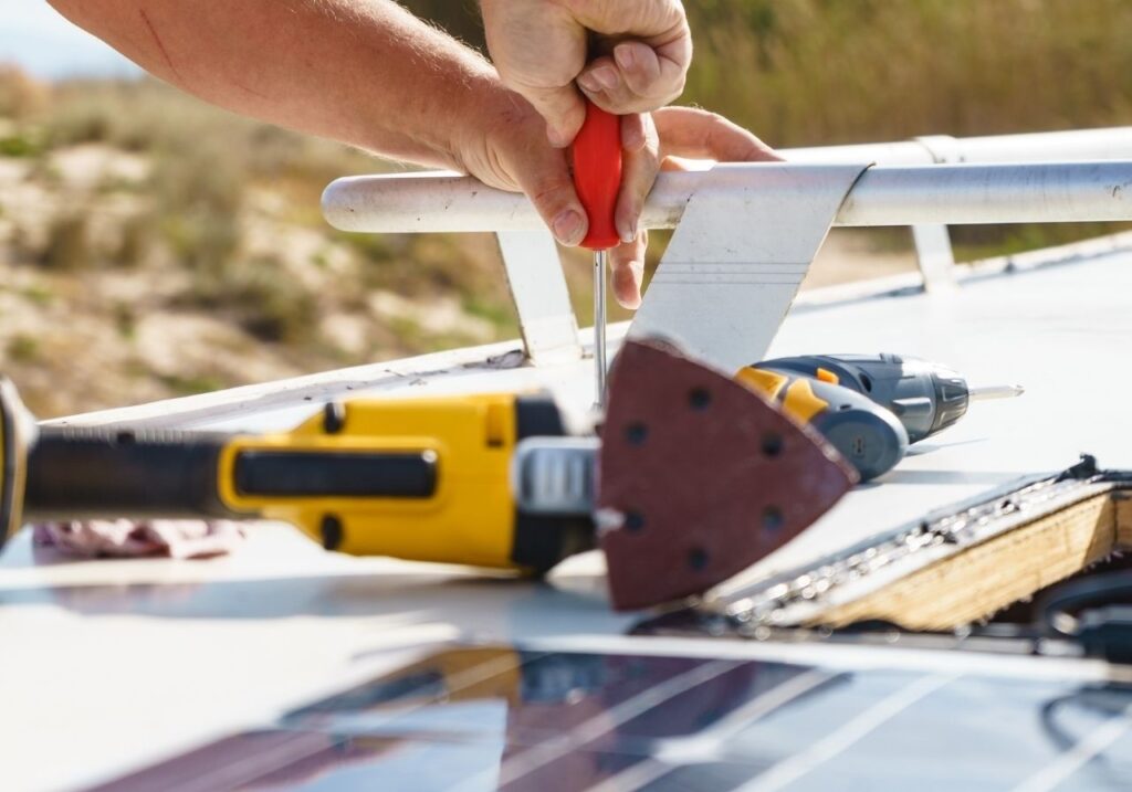 Technician arriving for same-day RV roof repair at a residential driveway